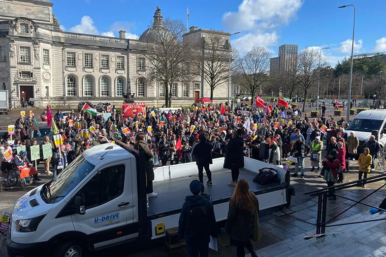 Hundreds of anti-racist protesters ion Cardiff under a blue sky