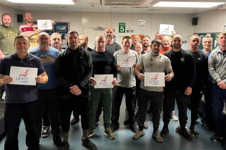 North Sea strikers hold Unite union signs on a rig in the north sea
