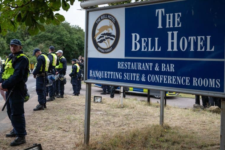 Sign outside the Epping Bell Hotel with armed cops