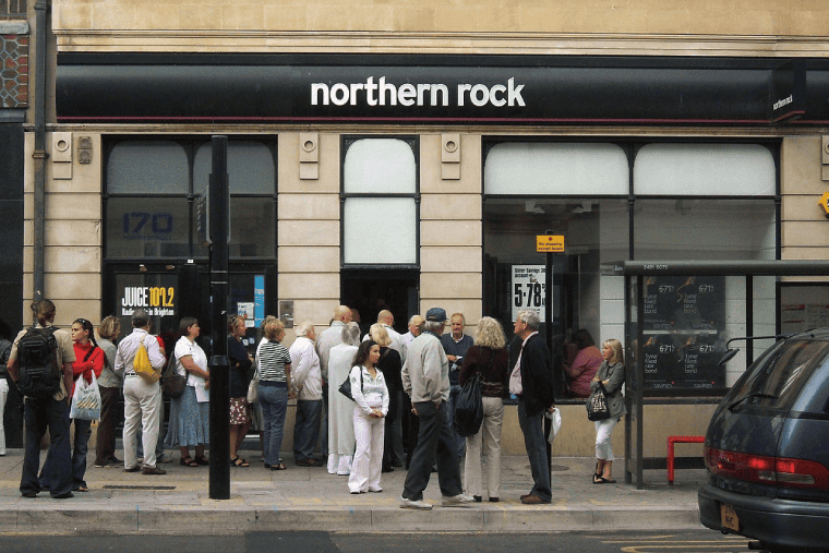 People queueing outside a Northern Rock branch in the United Kingdom to withdraw their savings during the financial crisis