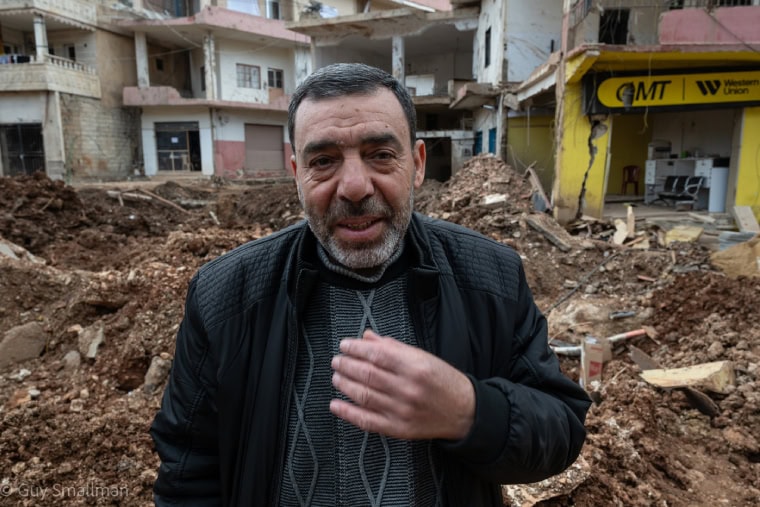 Man stands amid the wreckage of Nabi Chit (Photo: Guy Smallman)