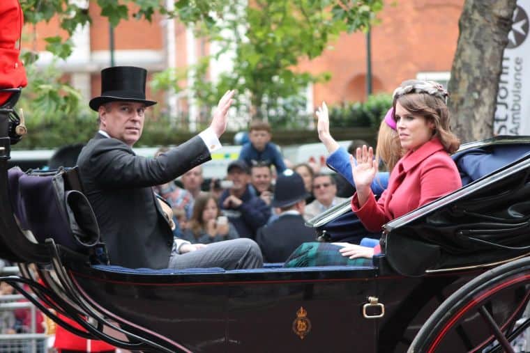 Former prince Andrew in a top hat in a carriage with his daughter