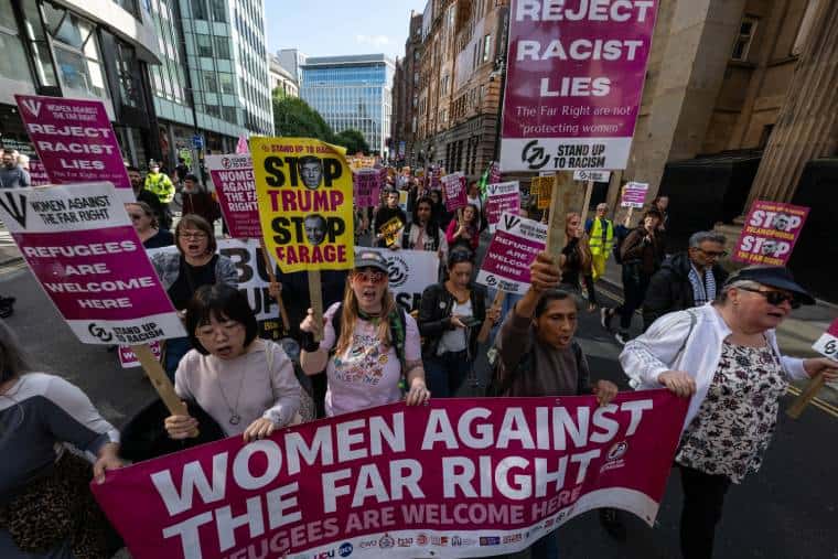 Women Against the Far Right lead the march in Manchester with their banner