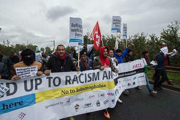 Angry refugees lead a march in Calais and celebrate solidarity